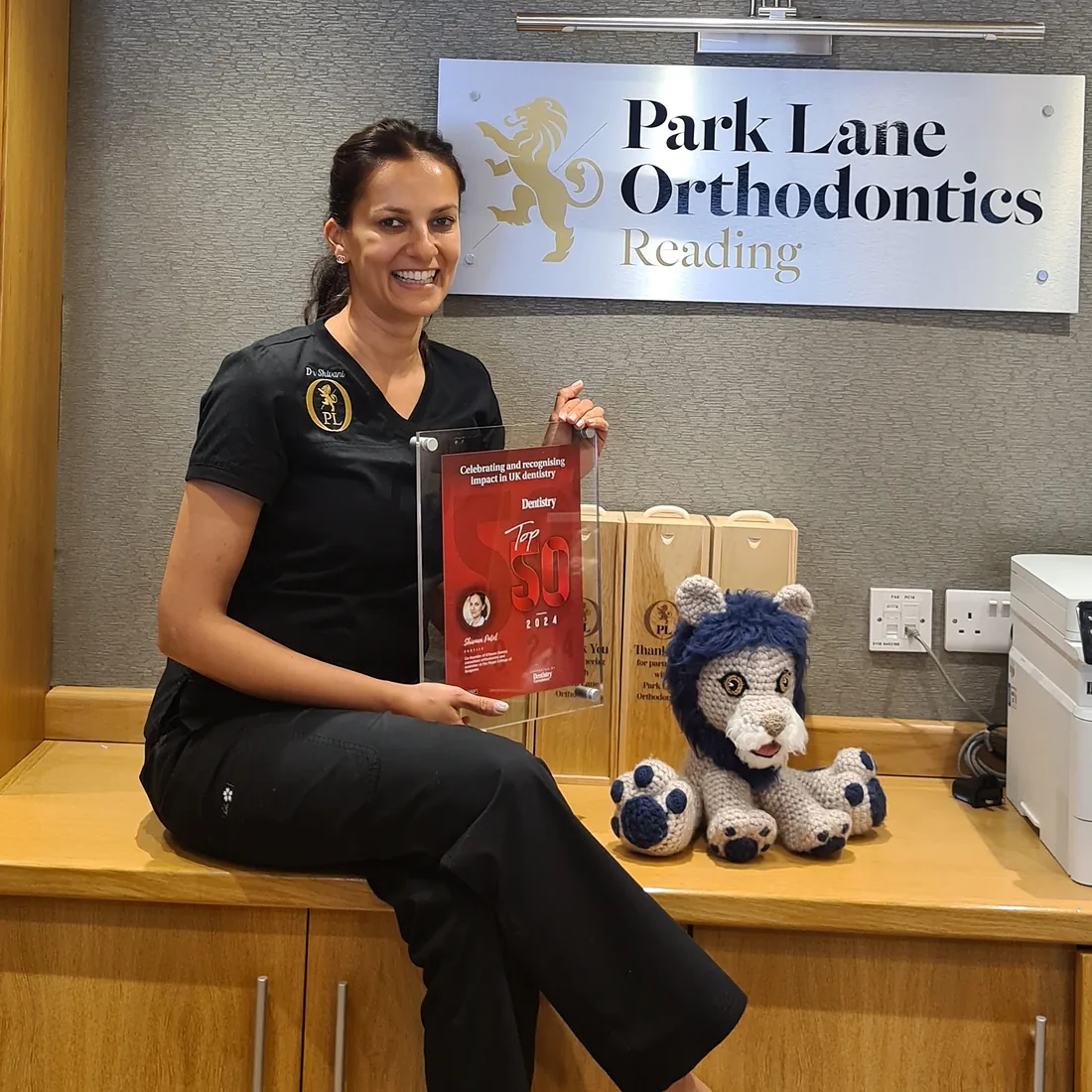 Consultant orthodontist Dr Shivani Patel with the practice's Dentistry Top 50 award at Park Lane Orthodontics