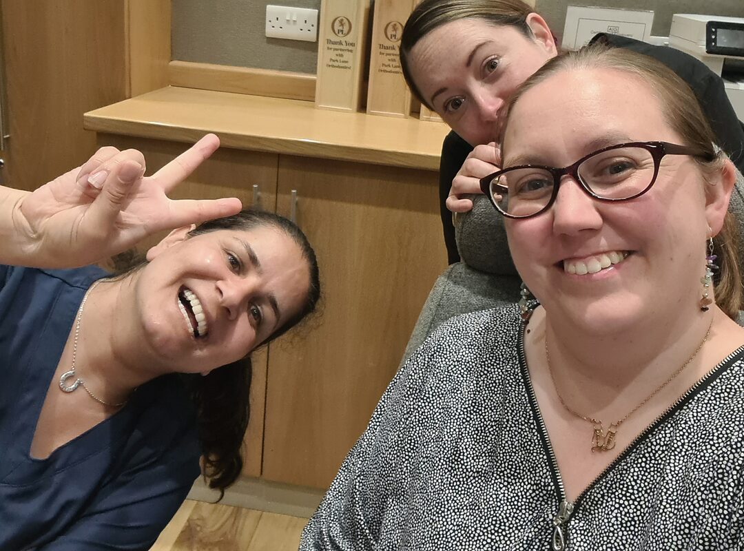 Three Park Lane Orthodontics team members laughing together at the practice