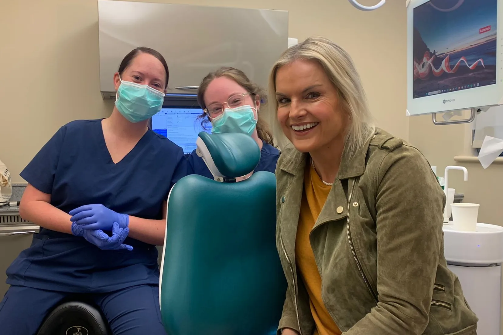 The Park Lane Orthodontics clinical team with a smiling patient in the treatment room