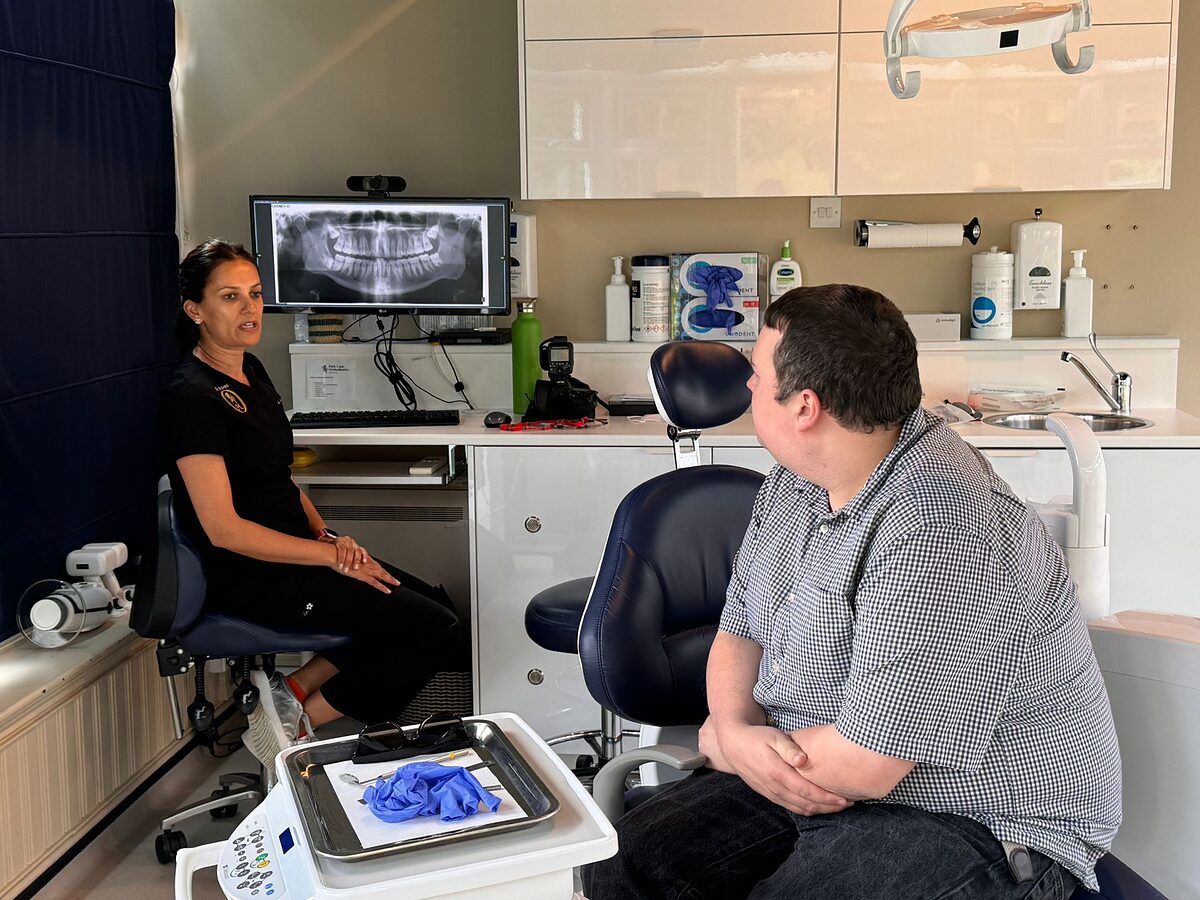 Orthodontist at Park Lane Orthodontics talking a patient through their x-ray and treatment plan